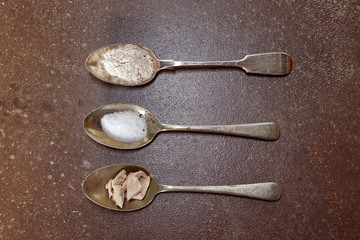 spoons with flour, salt and yeast