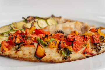 Baked fish with vegetables, zucchini and tomatoes