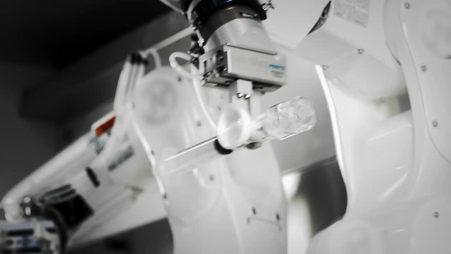 The innovative arms of a robotic arm make an injection of chemotherapy for a cancer patient. New technologies in medicine. Two manipulators draw medicine into a syringe. Hazardous substance injected