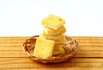 crispy butter and sugar bread in bamboo basket on wooden board. snack for relax time
