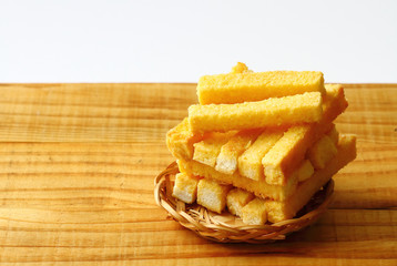 crispy butter and sugar bread in bamboo basket on wooden board. snack for relax time