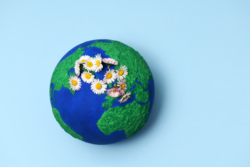 Earth model planet with daisies