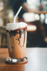 Iced mocha coffee with chocolate cream poured into glass it showing the texture