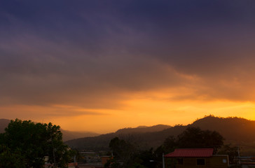sunset orange and yellow cumulus clouds in a summer day