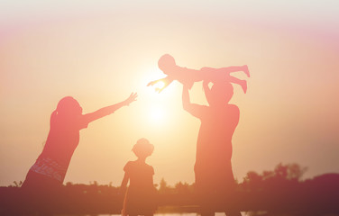 silhouette of a happy family and happy time sunset