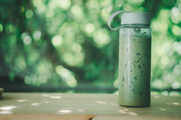 Iced coffee in plastic bottle with green lid. Concept of a zero waste campaign