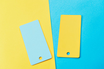 abstract composition of 2 design cards, comparison of two yellow and blue colored cards on a...