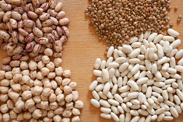 beans, chickpeas and lentils rest on a wooden table  with copy space for your text