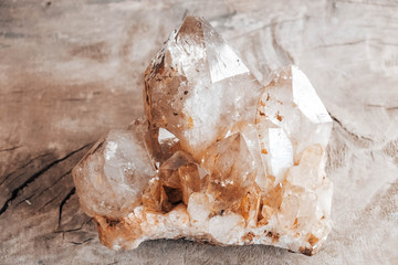 Quartz crystal on a wooden background. Copy, empty space for text
