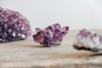 Violet amethyst crystal on wooden background. Copy, empty space for text