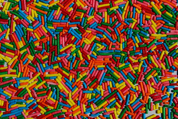 Colorful candies background with a lot of copy space for text. Many multicolored candy sweets. Abstract colorful pattern.
