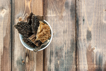 Dry tripe  - a treat for dogs in a white bowl on a wooden background. Pet food