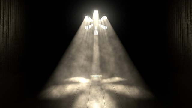 Sun shines through industrial factory fan with sunbeams lighting a dark factory room floor. Industrial seamless loop abstract background.