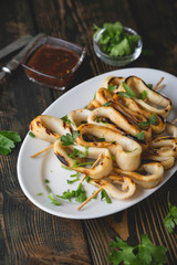 Grilled squid rings on a skewer