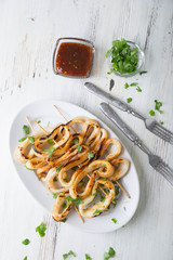 Grilled squid rings on a skewer