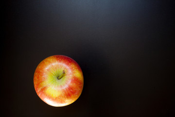 Apple on black table, food background