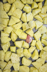 Chopped raw potatoes with oil and romarin