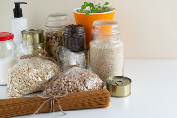 Stocks of various products at the time of quarantine. Pecets with pasta, oatmeal, rice, chickpeas, coffee, canned vegetables and sugar.  Coronavirus concept - stay home, be safe.