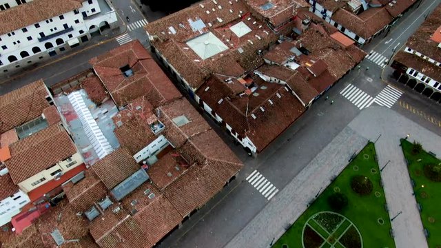 Daytime 4k Aerial footage over Plaza de Armas, wide angle tilt up and reveal shot of Plaza Kusipata and the west side of Cusco city, Peru during Coronavirus lockdown.