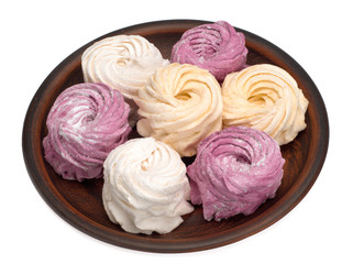 Marshmallow zephyr in a plate on a white background