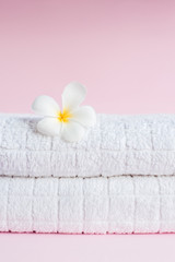 Fototapeta na wymiar SPA White pluneria flower on white towel