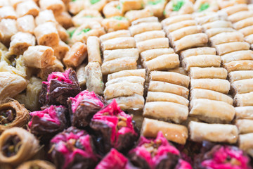 Various types or many colorful assortment of Turkish sweet rolls with nuts and almond.