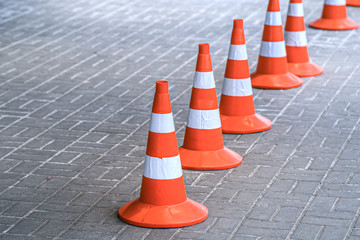 Traffic cones, protective signal plastic orange chips. Road works are carried out in a safe environment.