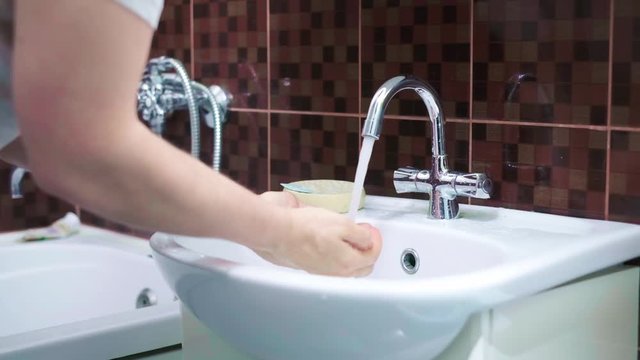 Morning Hygiene. Man Washing Face With Clean Water At Bathroom.