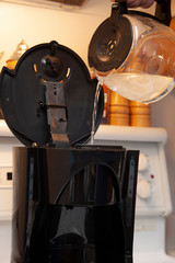 pouring water into coffee pot