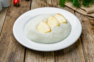 mamaliga with cheese on wooden table, Georgian cuisine