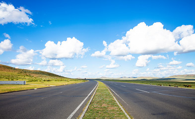 Empty highway, blue sky and white clouds landscape