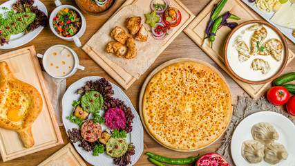Georgian cuisine foodset from khachapuri, khinkali, pkhali, dolma, satsivi, chicken kebab, vegetables top view