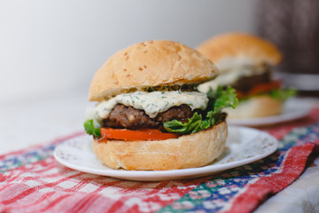 Small homemade burgers lie on a plate. juicy photo with blur closeup