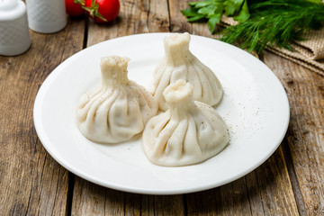 Khinkali with lamb on wooden table