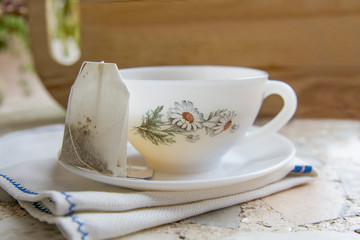 cup of chamomile tea with lemon on a neutral background
