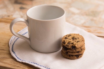 Cup of coffee with cookies on a napkin.