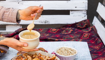 Peanut butter on spoon for vegan healthy food breakfast with fruits.   