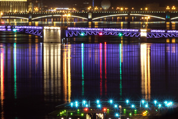 night view on river in the city, reflecting lights