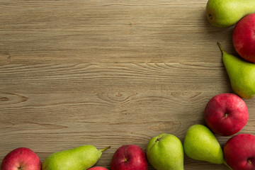 Apples and pears on wooden table