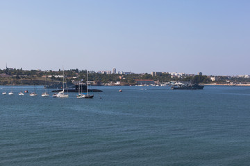 Sea minesweeper Zheleznyakov and Turbinist pass along the line of military ships at the parade on Navy Day in Sevastopol Bay, Crimea