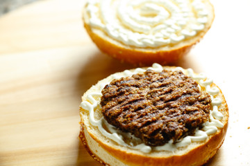 beef patty lies on a bun for a burger closeup