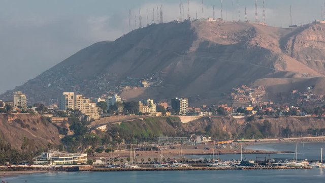 Aerial view of Lima's Coastline with Morro Solar hill in background timelapse, Lima, Peru. Harbor with yachts and beach with ocean. View from cliff near Circuito de Playas road