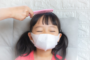 Little girl wearing mask for protect pm2.5 and Covid-19,sadness child at home in isolation,Coronavirus and Air pollution pm2.5 stop corona virus outbreak.Wuhan coronavirus and epidemic virus symptoms.