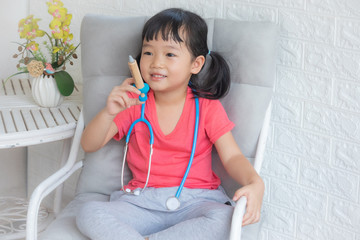 Little girl playing a doctor,boy and girl playing doctor and patient isolated,Two children play doctor and hospital using stethoscope,Sister and brother having fun at home or preschool,Tool doctor.