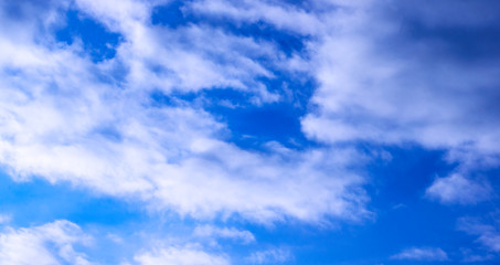 A blue sky is visible through the clouds in the early morning at sunrise.