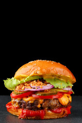 tasty burger with beef on dark isolated background. Homemade hamburger or burger with fresh vegetables and cheese