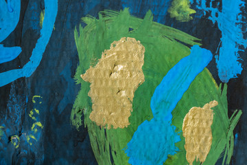 Gold spots on a green circle and on a blue background children’s gouache drawing on cardboard