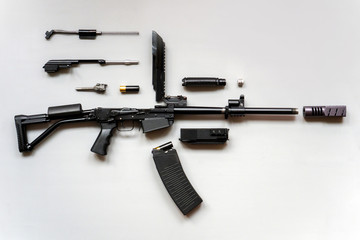 Disassembled machine gun on a gray background. Isolated. Details of firearms in a disassembled state