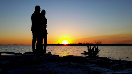 couple in love at sunset by the lake