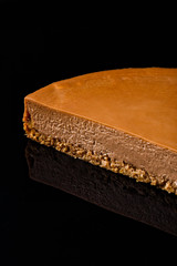 Tiramisu layered with crumbled buttered biscuit, cocoa moose coated with dark chocolate. Confectionery photography concept.